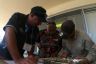 Sea ranger Kelvin Rowe, Uncle Mick Eggmolesse and sea ranger Darren Hodges working together to identify different species of seagrass. Uncle Mick knows which ones are the favourites of turtle and dugong.